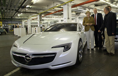 Bundeskanzlerin Angela Merkel wurde bei Opel von Unternehmenschef Nick Reilly sowie dem Gesamtbetriebsratsvorsitzenden Klaus Franz (rechts) begrüßt und schaute sich das Konzeptfahrzeug Flextrme GT/E an.