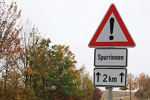 Die Bedeutung von Zusatzzeichen ist Autofahrern nicht immer klar. Hier deuten die Entfernungsangabe mit Pfeilen darauf hin, dass die Gefahr von Spurrinnen auf den folgenden zwei Kilometern besteht.