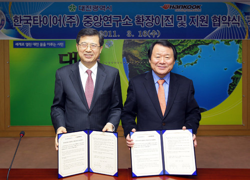 Hankook-Vizepräsident und Vorstandsvorsitzender Seung Hwa Suh (links) und Bürgermeister Hong-Chul Yum (rechts) unterzeichnen die Vereinbarung für den Standortwechsel des Forschungs- und Entwicklungszentrums nach Daejeon.