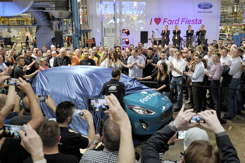 Start der Produktion des neuen Ford Fiesta (v.r.): Mitarbeiter aus der Fertigung enthüllen ein Modell des Kleinwagens in Lagun-Blau Metallic.