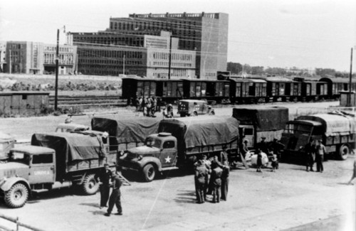 US-Truppen am Bahnhof von Wolfsburg mit dem Kraftwerk des Volkswagenwerks im Hintergrund.